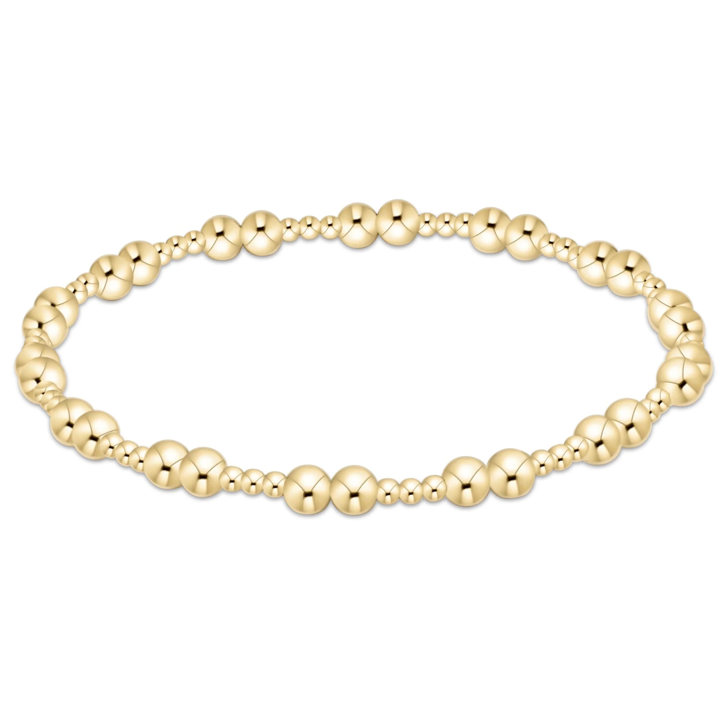 Gold beaded bracelet on a white background