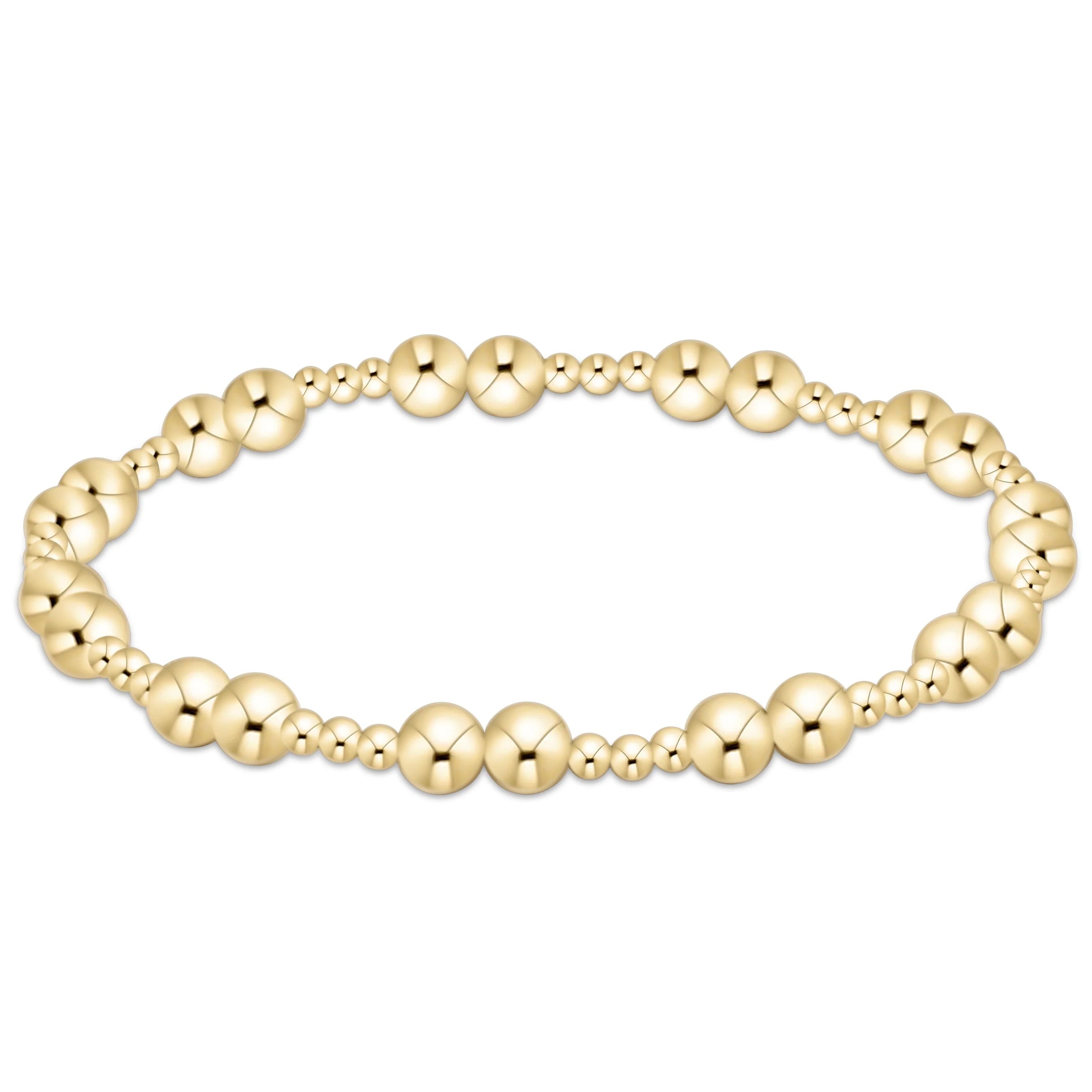 Gold beaded bracelet on a white background