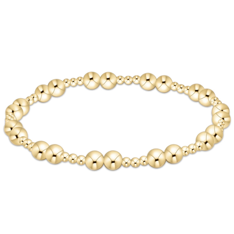Gold beaded bracelet on a white background