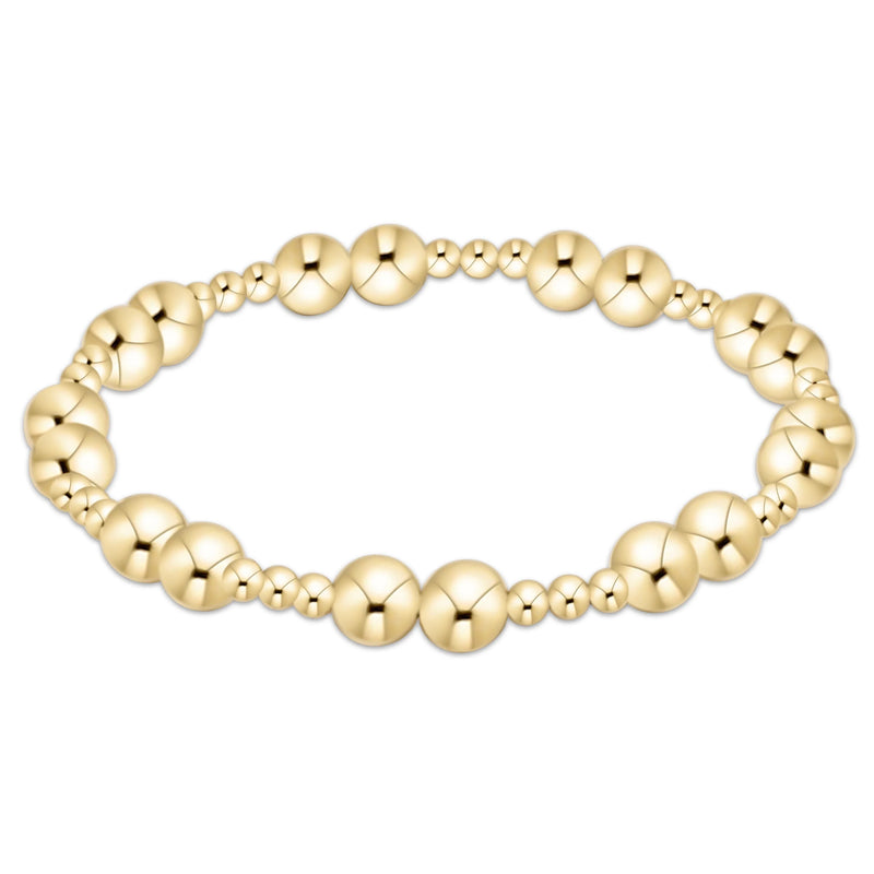 Gold beaded bracelet on a white background