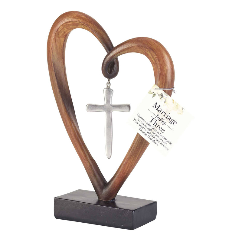 Wooden heart-shaped object with a cross and text tag on a white background