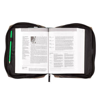 Black zippered pouch with an open book inside on a white background