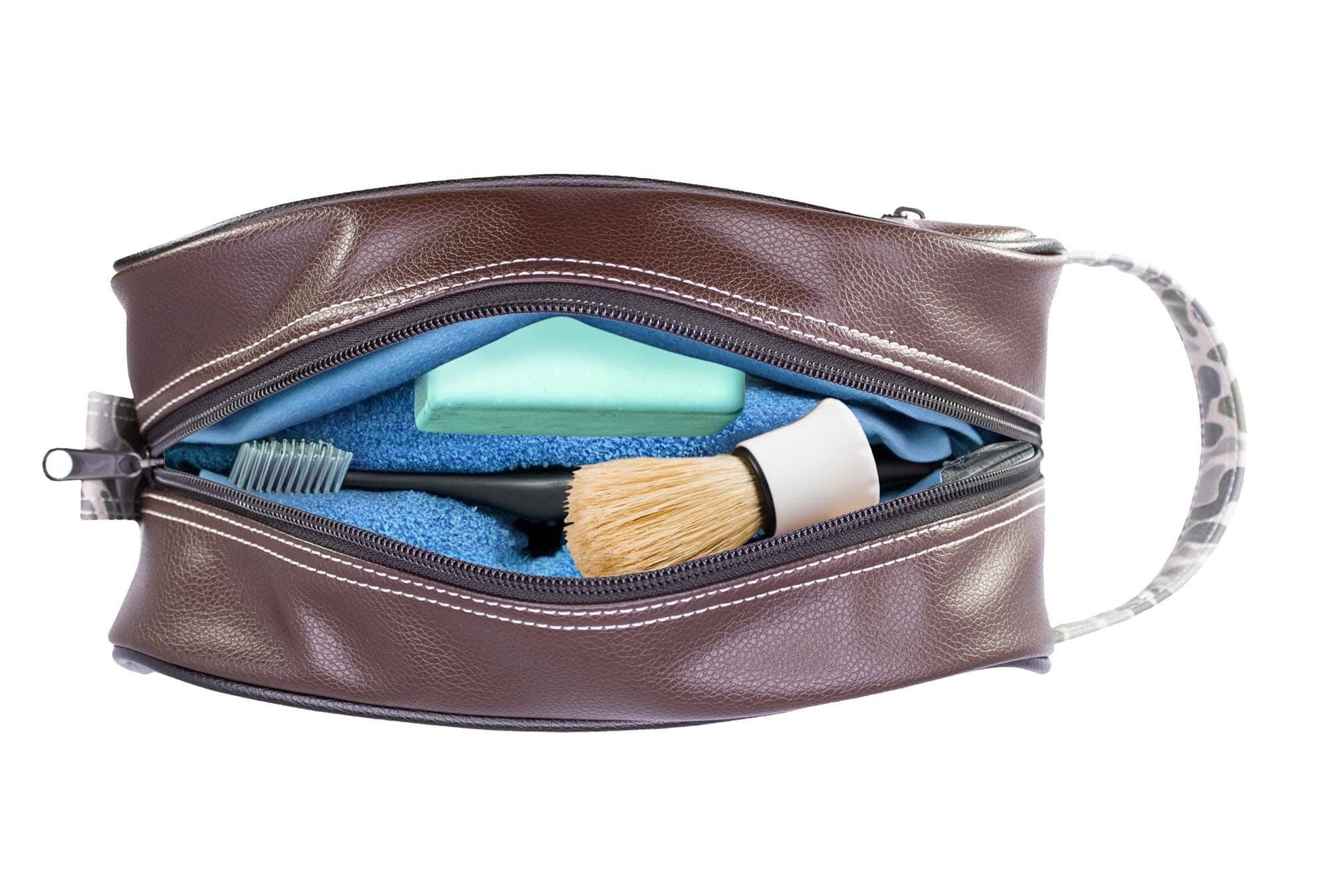 Brown leather toiletry bag with cleaning supplies on a white background
