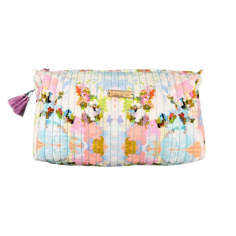 Floral patterned clutch bag with a tassel on a white background