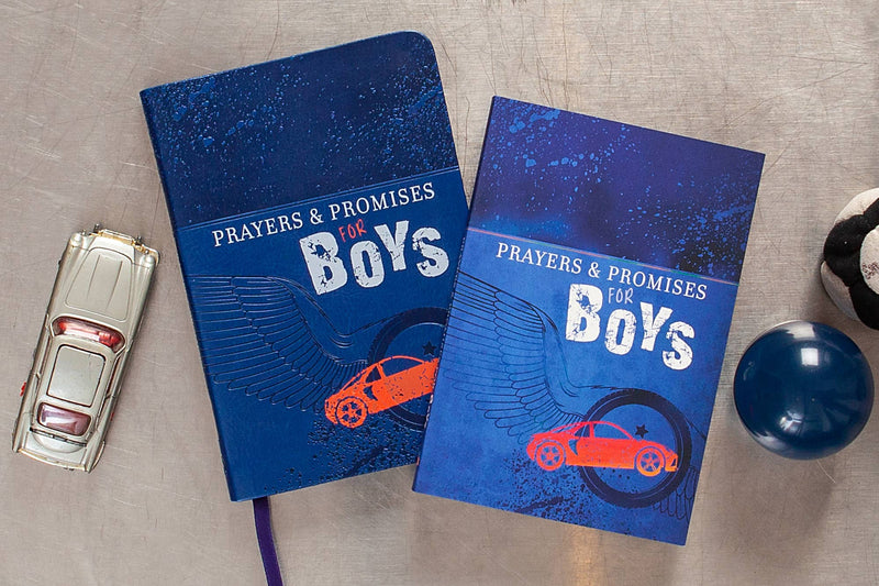Two blue books titled 'Prayers & Promises for Boys' on a gray surface with toys.