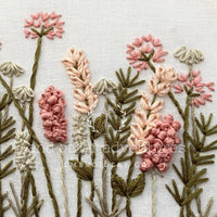 Embroidered floral design on fabric with 'outeradventures' branding.