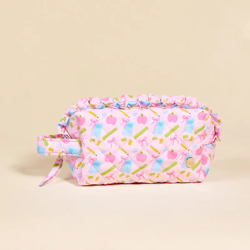 Pink cosmetic bag with colorful patterns on a beige background