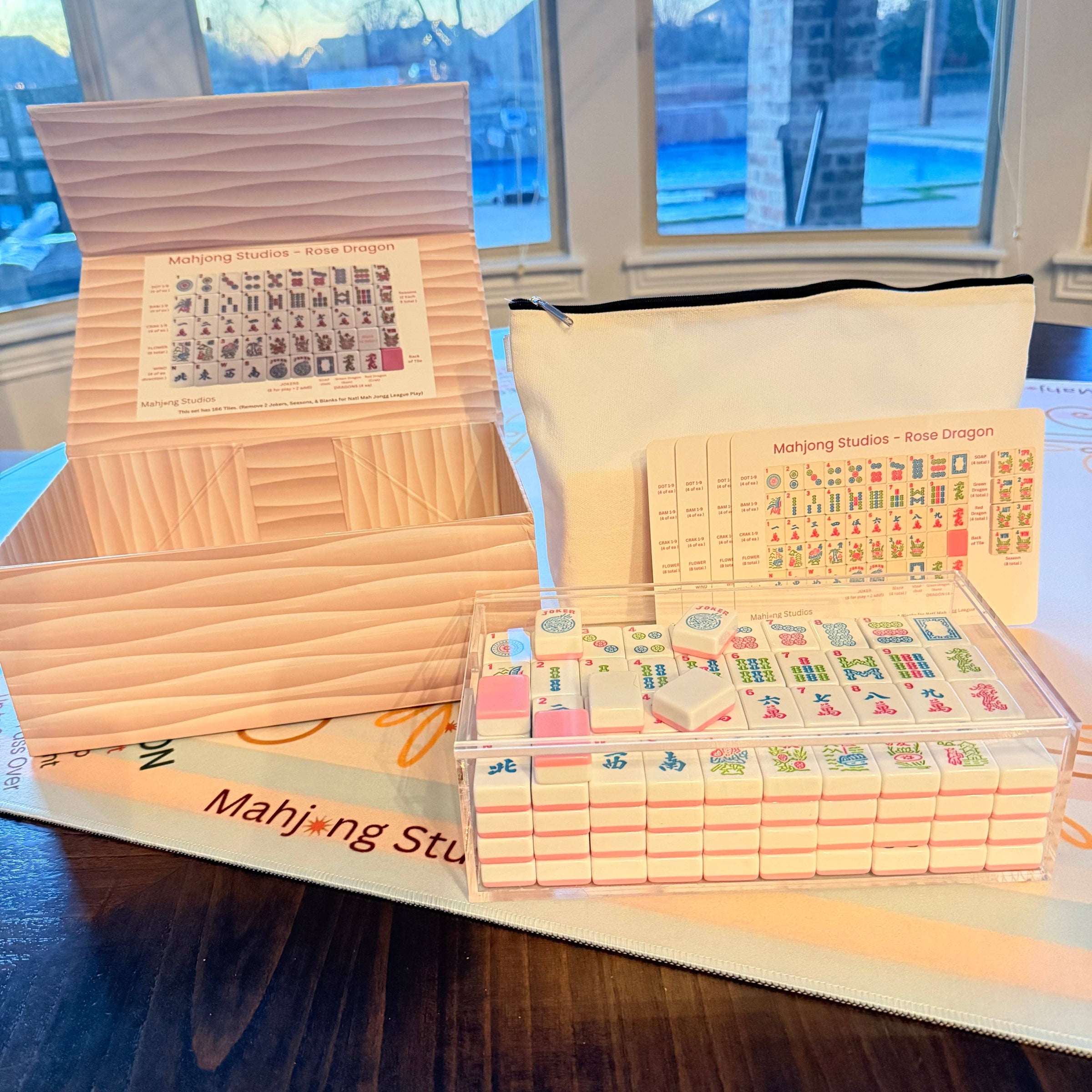 Mahjong set with packaging on a table by a window