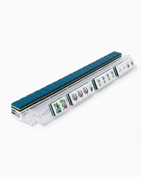 Set of mahjong tiles in a clear plastic case on a white background