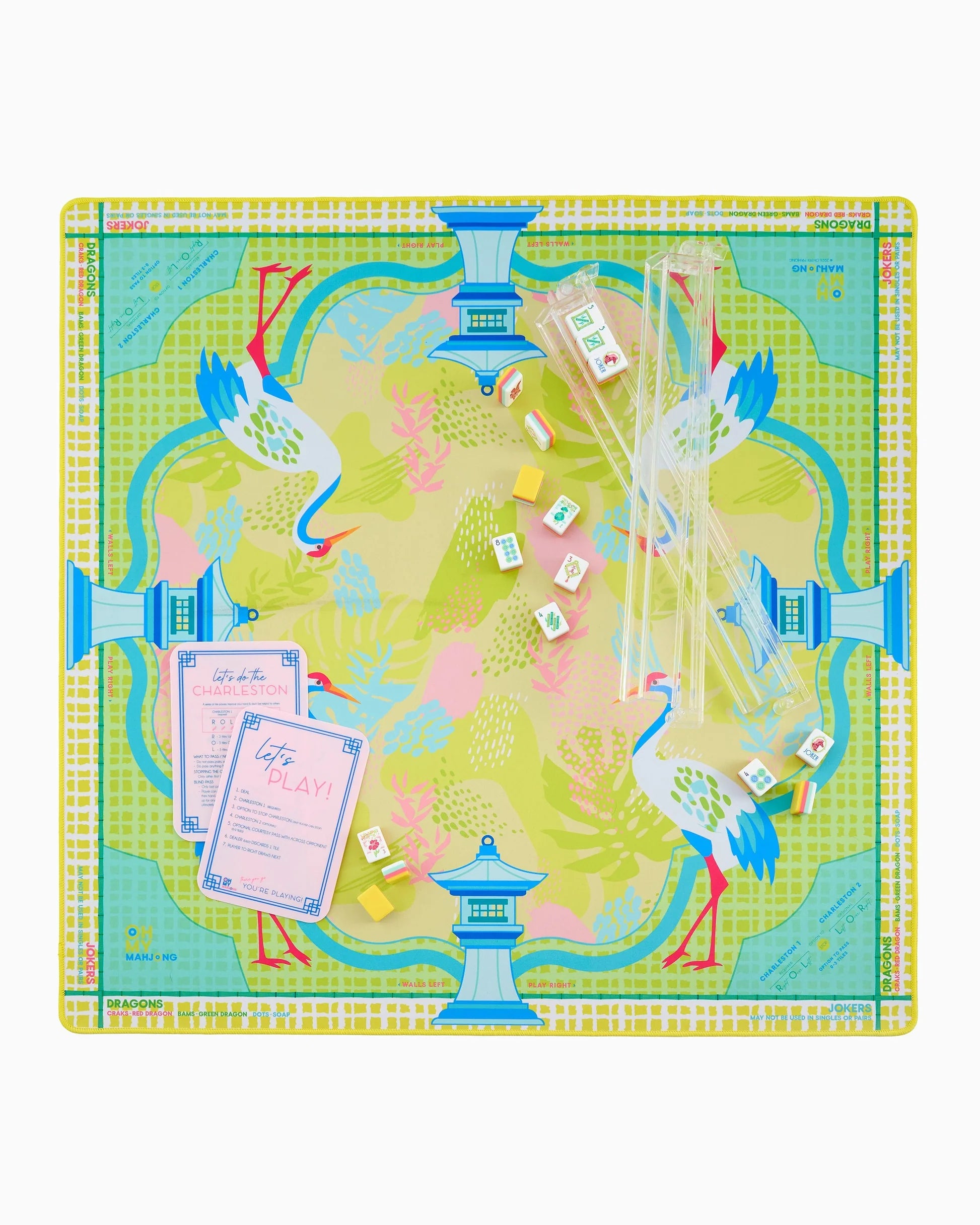 Colorful mahjong mat with bird and pagoda design on a white background