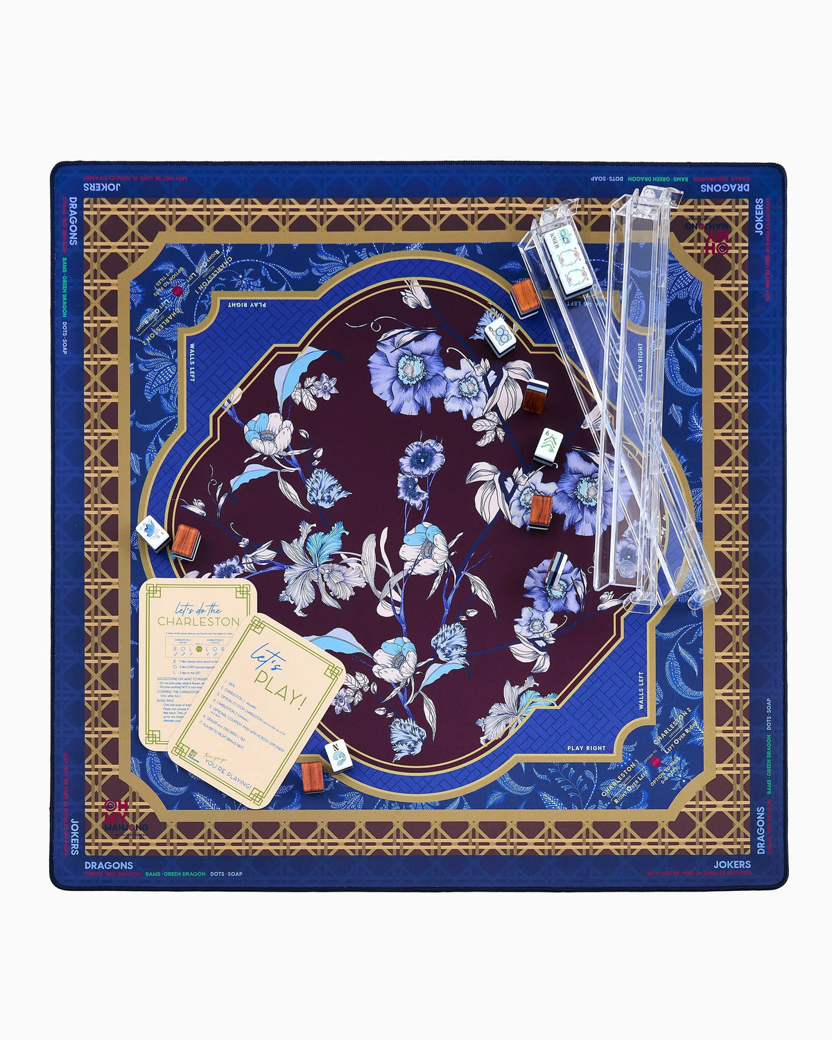 A square mahjong mat featuring an ornate floral design. The center is a deep burgundy oval with light blue and white flowers, surrounded by a gold geometric border and a blue outer border with blue floral motifs.