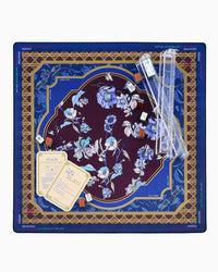 A square mahjong mat featuring an ornate floral design. The center is a deep burgundy oval with light blue and white flowers, surrounded by a gold geometric border and a blue outer border with blue floral motifs.