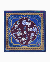 A square mahjong mat featuring an ornate floral design. The center is a deep burgundy oval with light blue and white flowers, surrounded by a gold geometric border and a blue outer border with blue floral motifs.