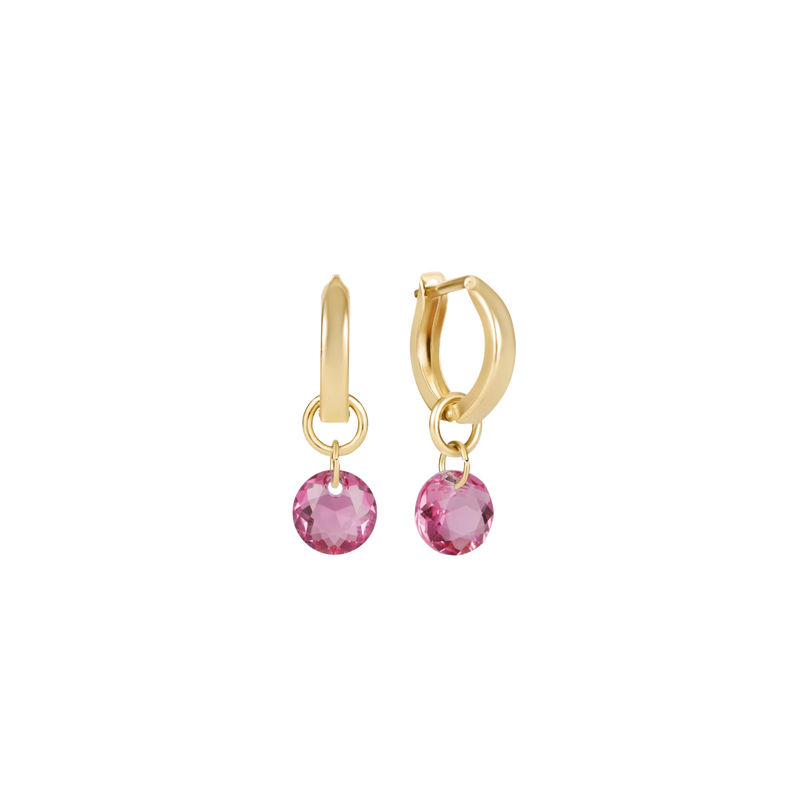Gold hoop earrings with pink gemstones on a white background