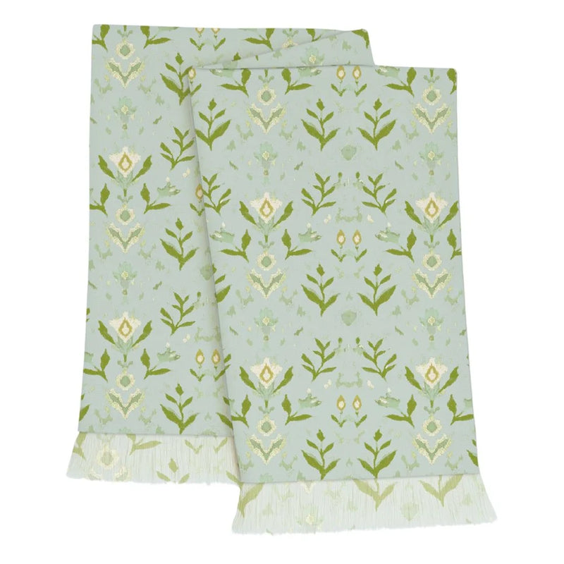 Fabric with green floral pattern on a light blue background