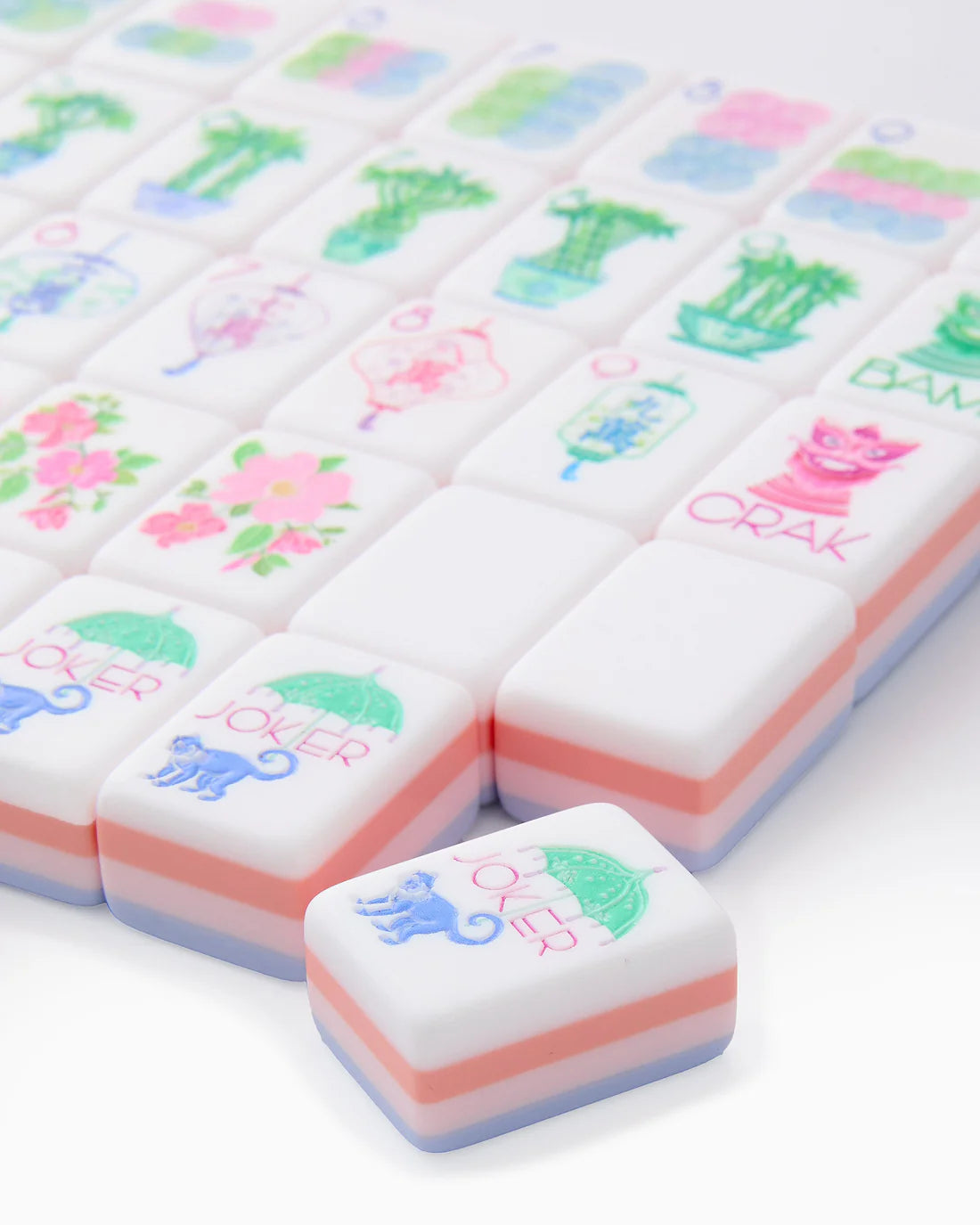 Colorful mahjong tiles with cartoon illustrations on a white background