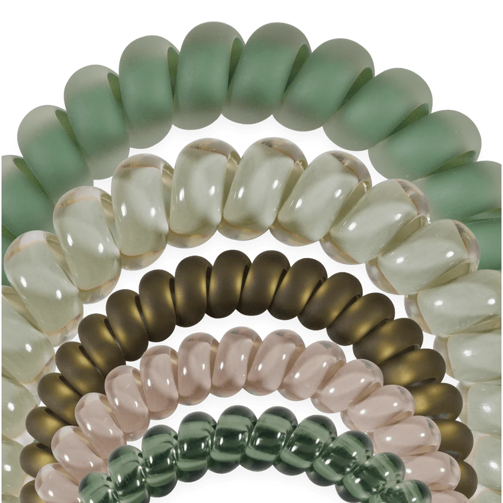 A close-up studio shot of multiple translucent beaded bracelets arranged in overlapping arcs. The beads are smooth, rounded, and come in pale mint green, creamy off-white, smoky brown, blush pink, and dark green tones.