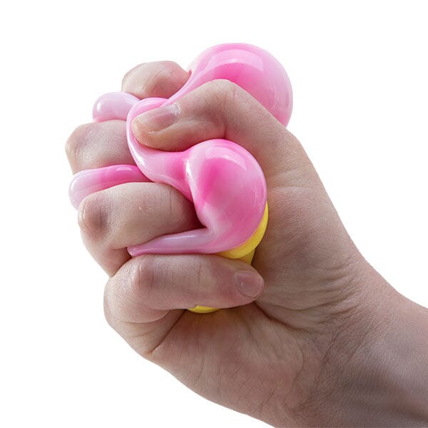 Hand squeezing a pink and yellow squishy toy against a white background