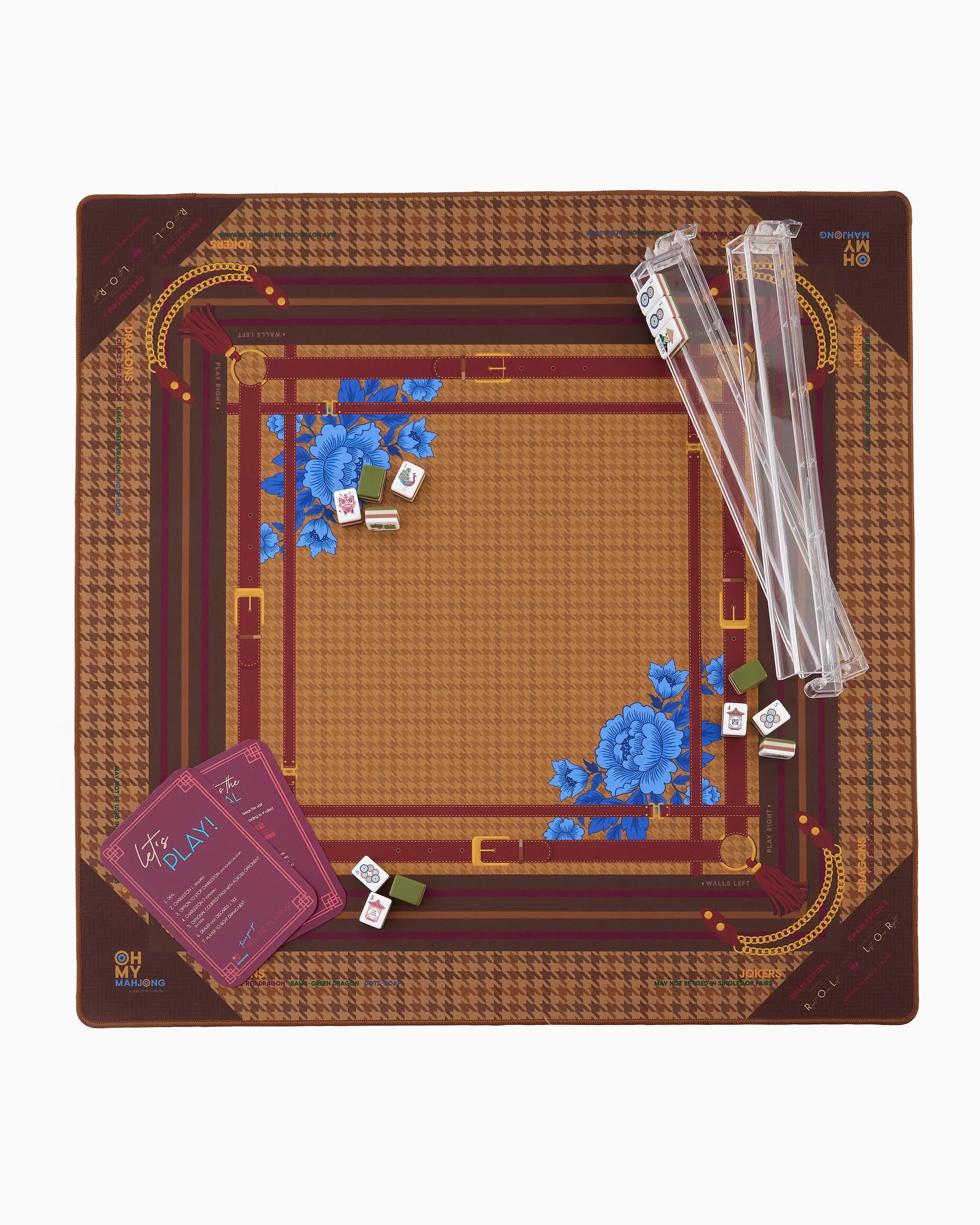 A top-down view of the Mahjong Mat on a clean white background. The square board features a brown and gold houndstooth pattern with a central tan grid, decorated with blue floral motifs in the corners.