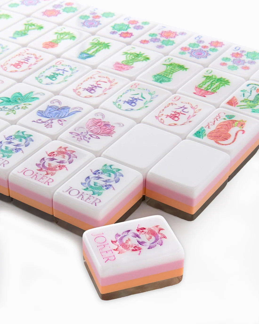 Colorful mahjong tiles with floral and animal designs on a white background