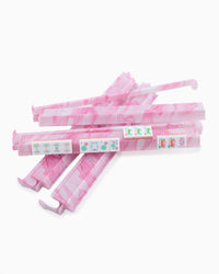 Pink and white striped mahjong rack on a white background