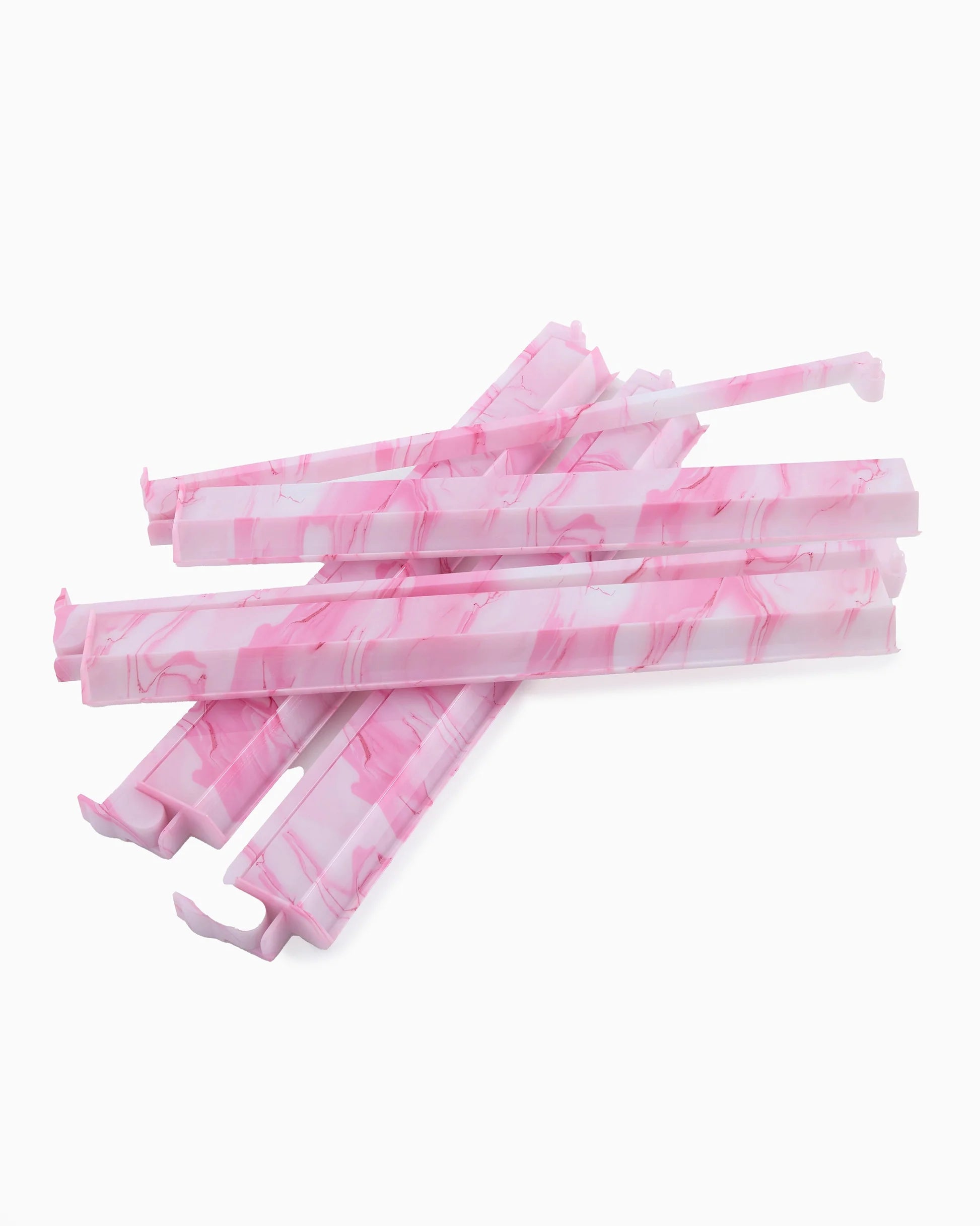 Pink and white marbled mahjong rack on a white background