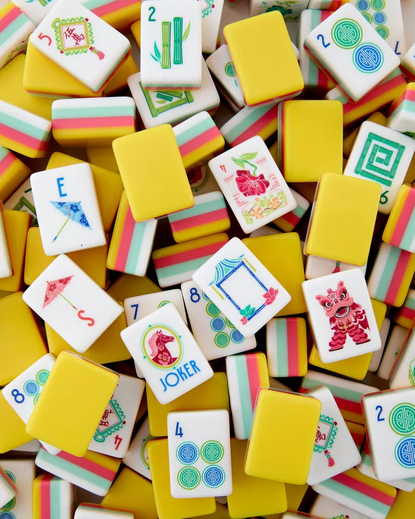 Colorful assortment of game tiles with various designs on a wooden surface
