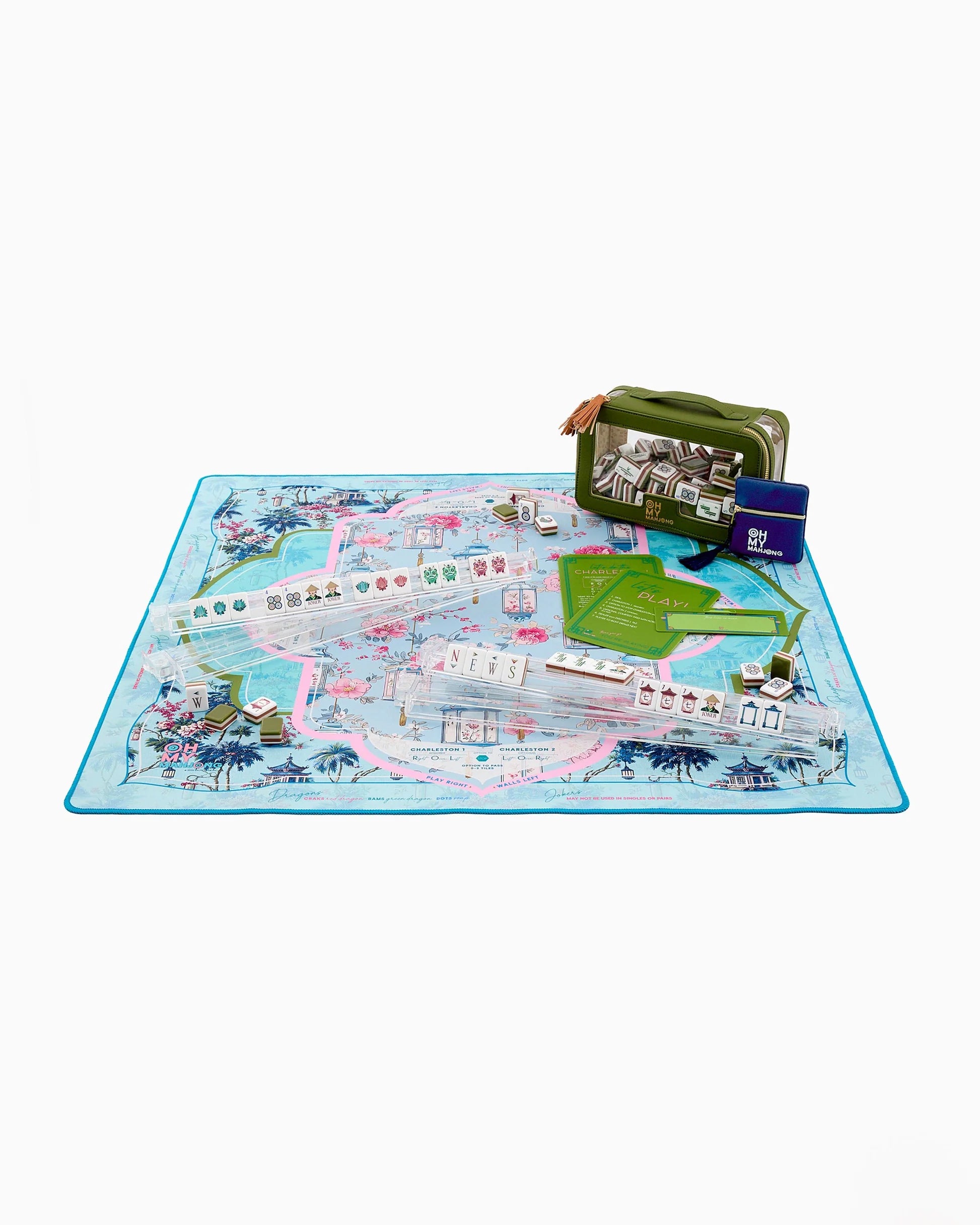 Decorative mahjong mat with floral and architectural design on a blue background