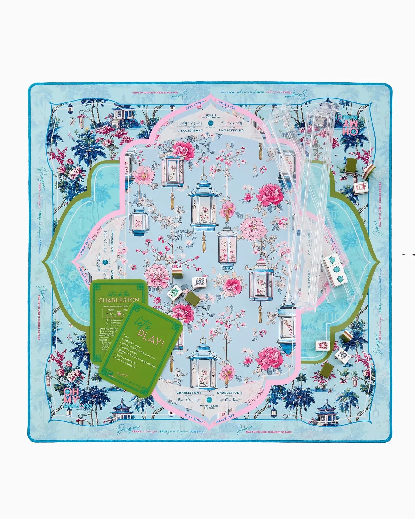 Decorative mahjong mat with floral and architectural design on a blue background