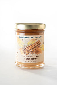 Jar of Savannah Bee Company whipped honey with cinnamon on a white background