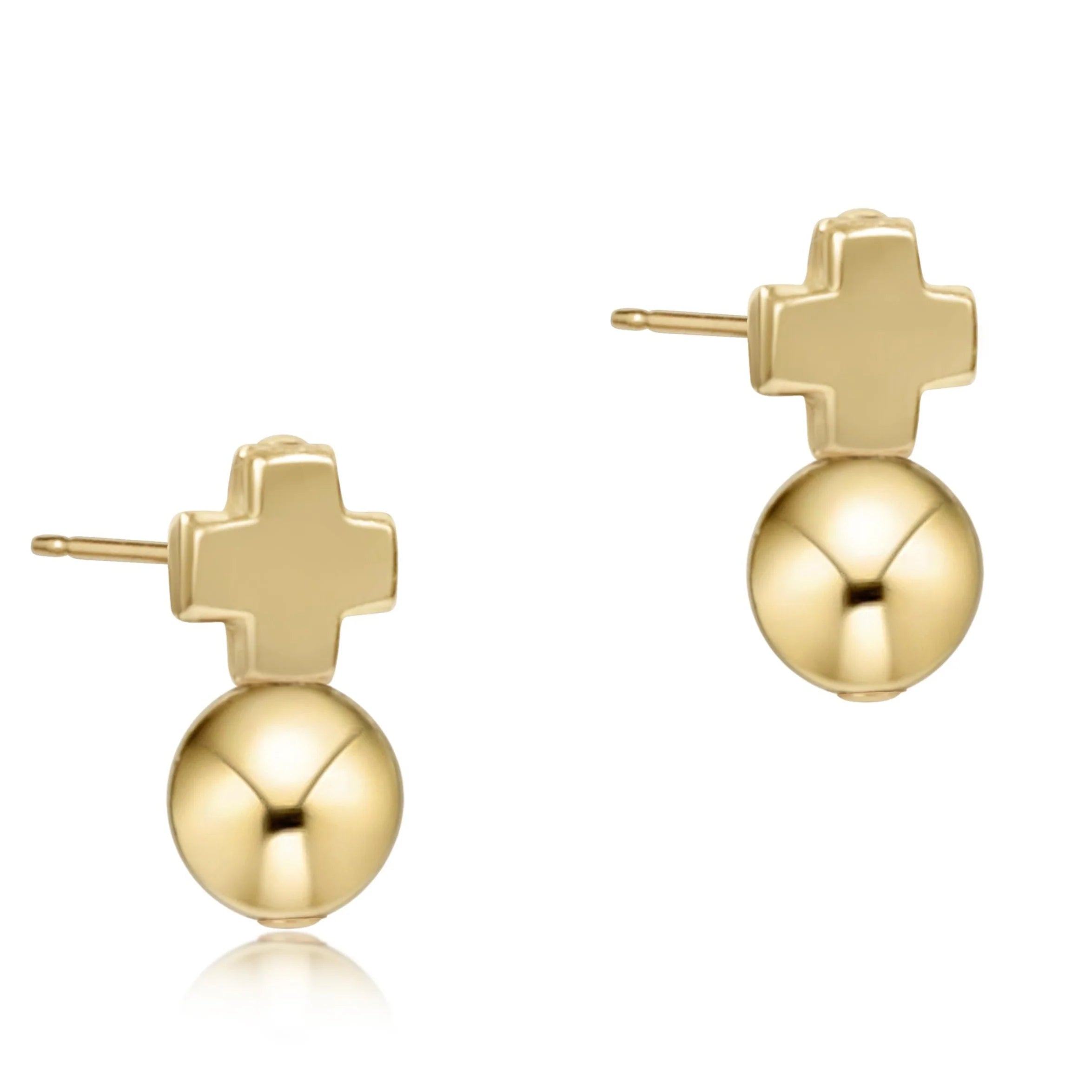 Gold earrings with cross and sphere design on a white background