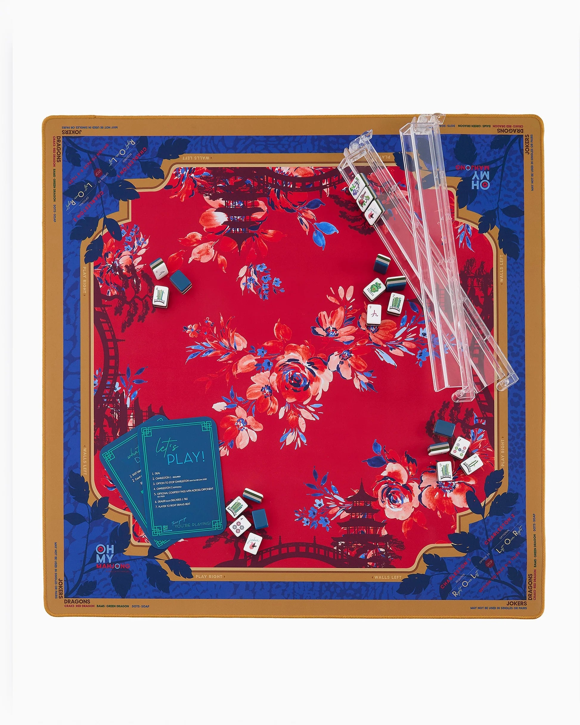Mahjong set with a decorative red and blue board, cards, and dice on a white background.