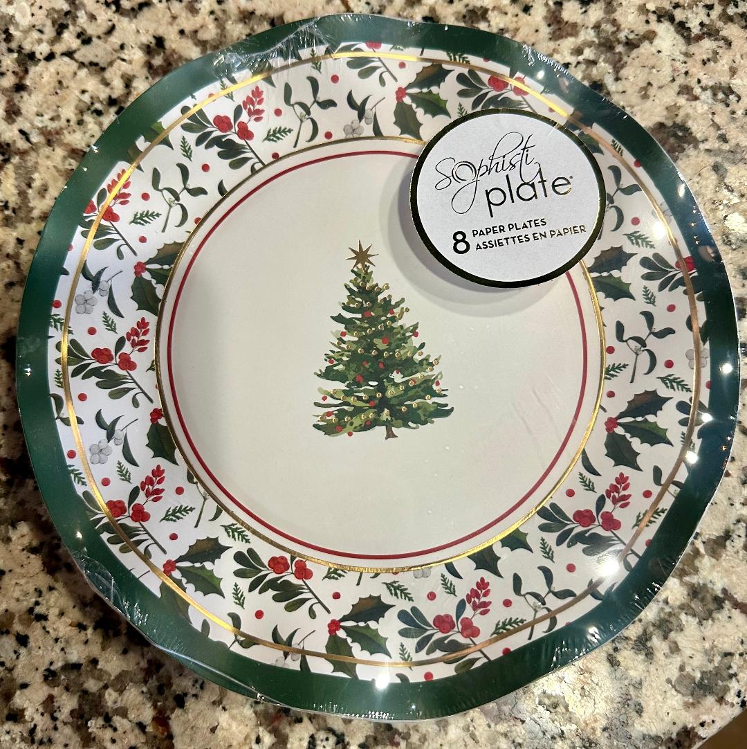 Packaged paper plates with Christmas tree design on a granite surface