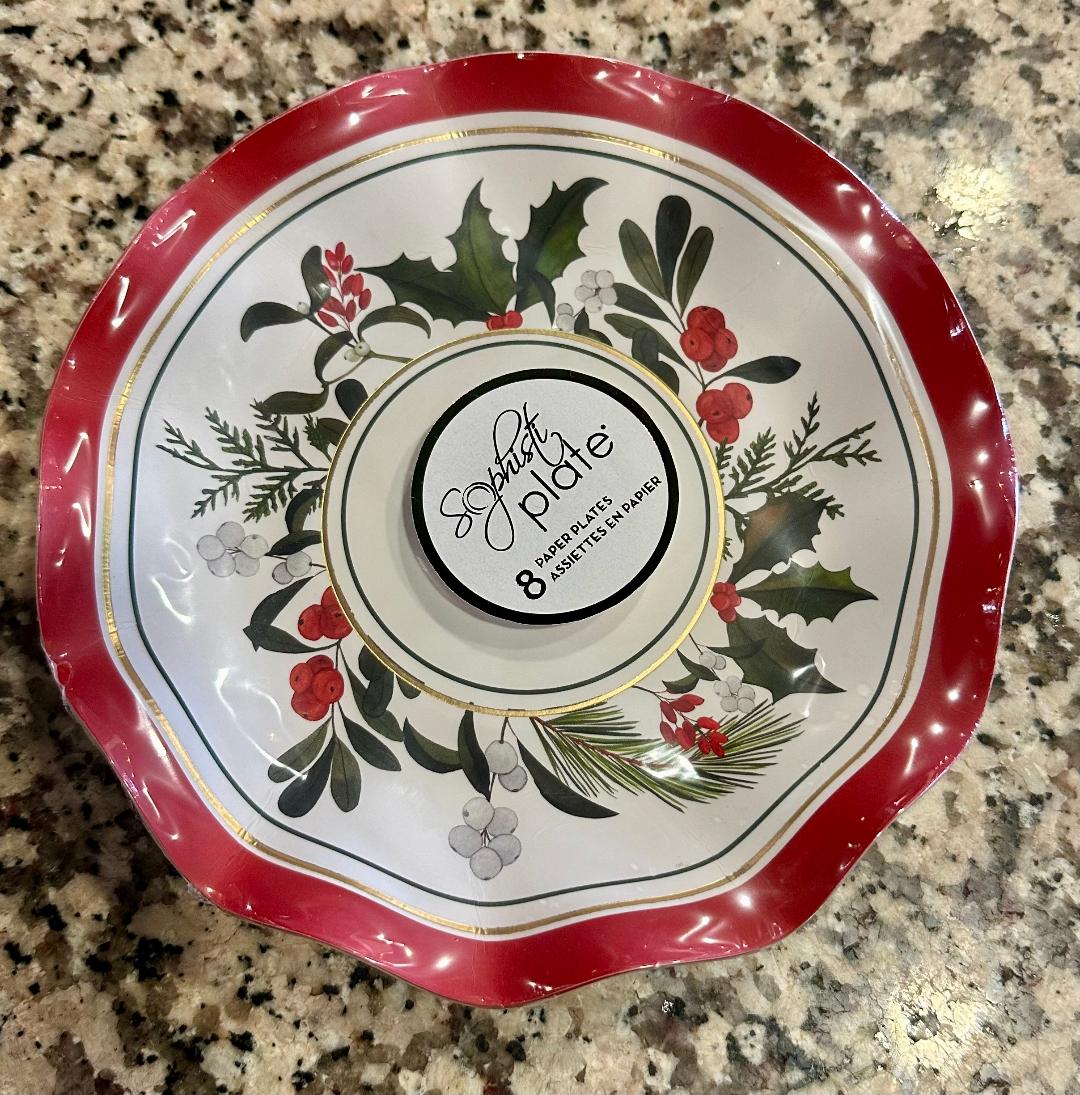 Decorative plate with holly design on a granite surface