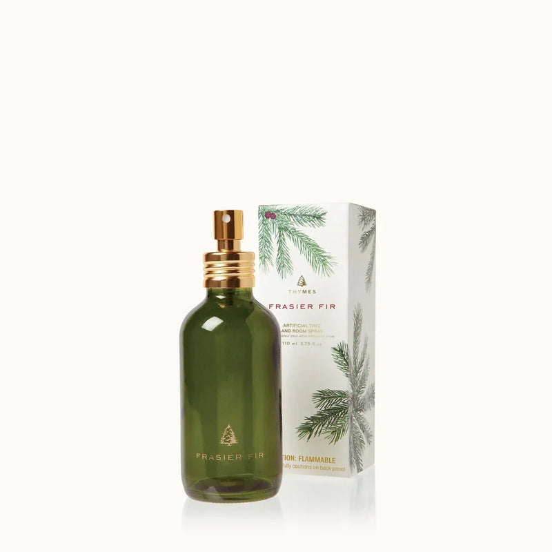 Green bottle with gold cap and matching box on a white background